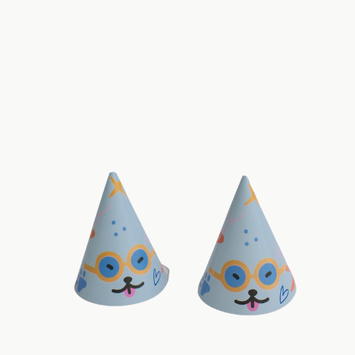 Two light-blue party hats with cartoon dog faces, round glasses, and pink tongues on a white background.