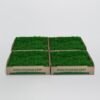 Four boxes of green artificial turf arranged in a 2x2 grid, with 'www.pipigrass.com' printed on the sides.