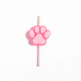 Pink paw-print candle placed on a white candle stick against a white background, isolated.