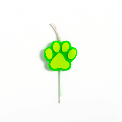 Green paw-print candle on a white stick with a wick at the top.